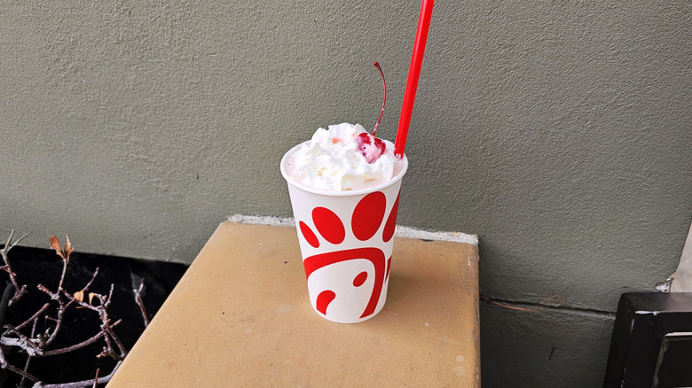 Chick-fil-A Peppermint Milkshake on bench outside