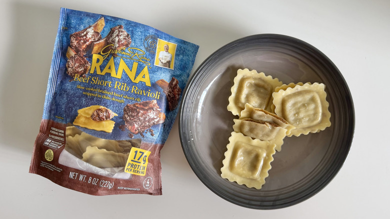 Pack of Beef Short Rib Ravioli by Rana on a table with some pieces displayed on a gray plate