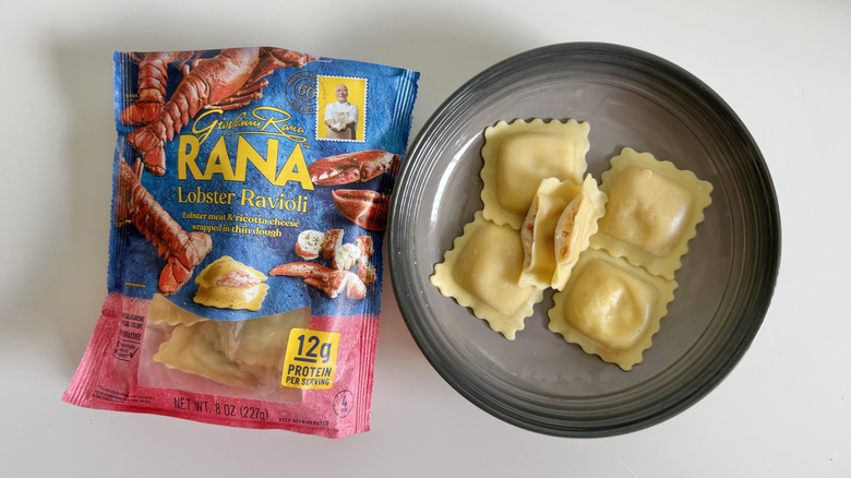 Lobster Ravioli package on a table with several pieces displayed on a gray plate next to it