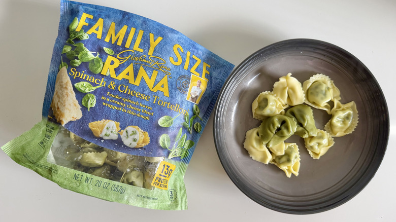 Spinach cheese Tortelloni pieces on a plate next to the tortelloni bag