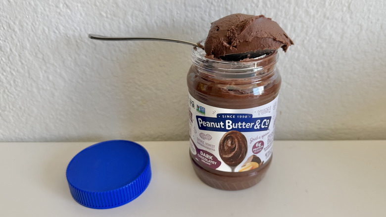 Peanut Butter & Co. Dark Chocolate Dreams jar with a spoonful of peanut butter on top