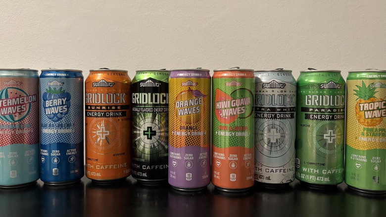 a range of aldi summit energy drink cans lined up on a table