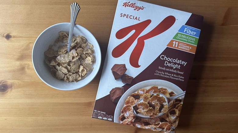 Special K Chocolatey Delight in white bowl on a wood table next to the cereal box.