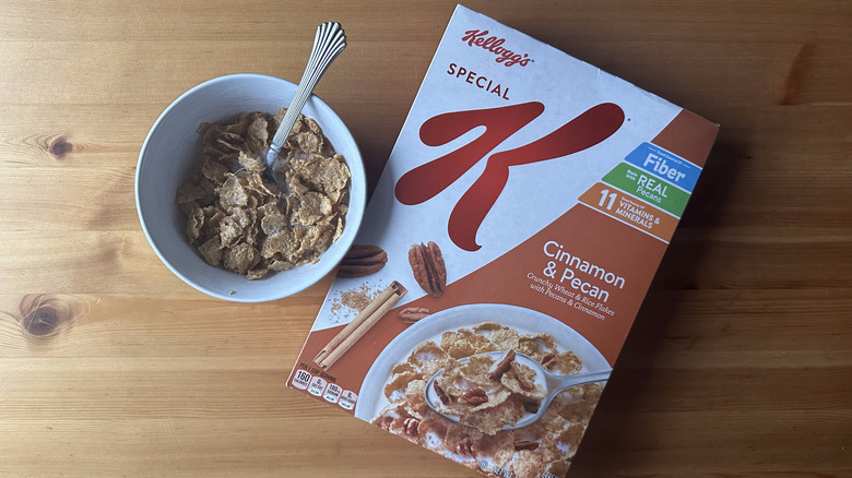 Special K Cinnamon and Pecan in white bowl on a wood table next to the cereal box.