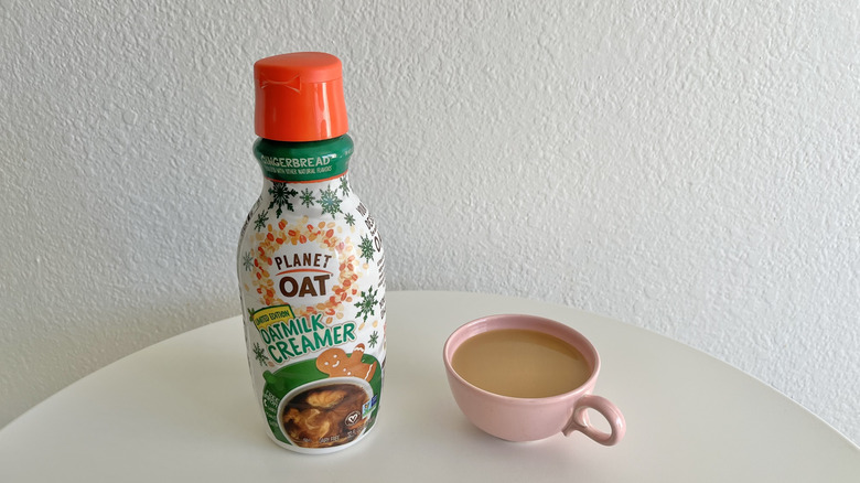 Planet Oat Gingerbread Creamer next to coffee