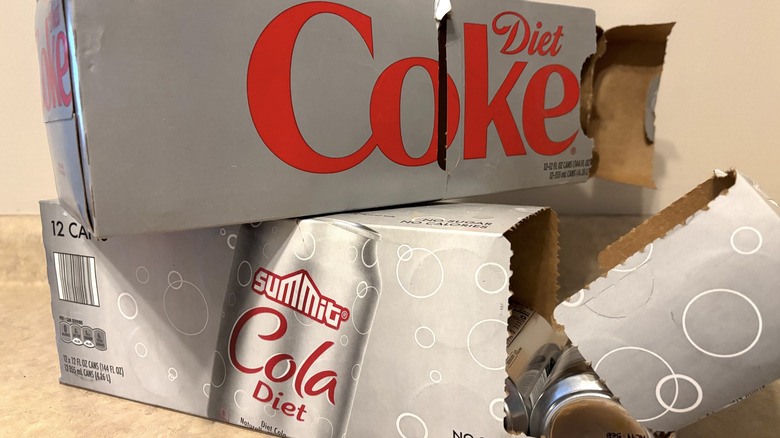 Aldi Summit diet cola and Diet Coke 12 pack boxes on neutral countertop