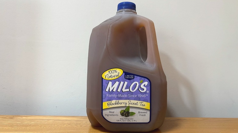 Gallon of Milo's Blackberry Sweet Tea on wooden table