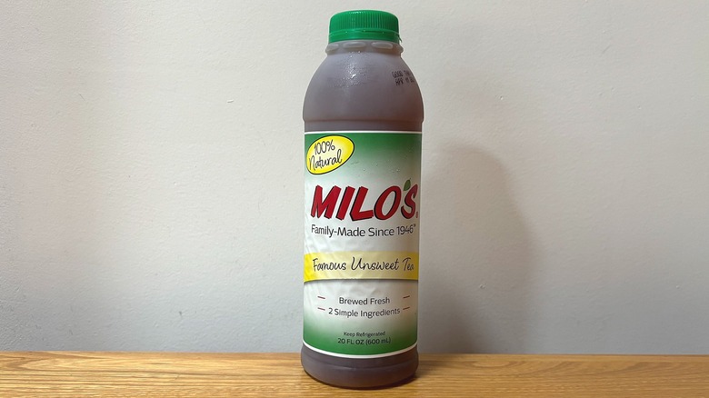 Bottle of Milo's Famous Unsweet Tea on wooden table