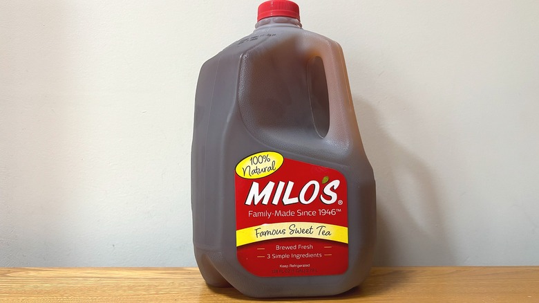 Gallon jug of Milo's Famous Sweet Tea on wooden table