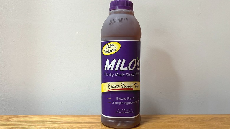 Bottle of Milo's Extra Sweet Tea on wooden table