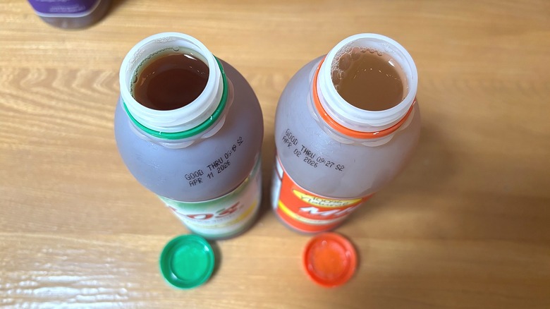 Top-down shot of two bottles of Milo's teas on wooden table