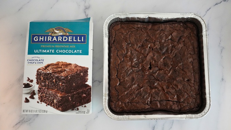 Ghirardelli Ultimate Chocolate Brownies in pan next to box on marble surface