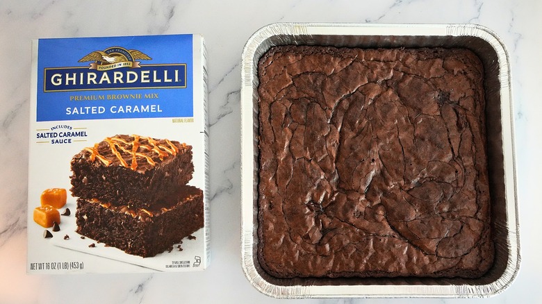 Ghirardelli Salted Caramel Brownies in pan next to box on marble surface