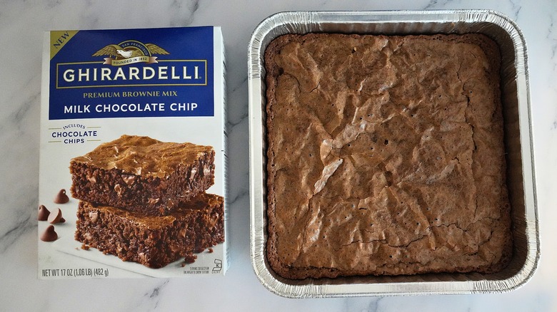 Ghirardelli Milk Chocolate Brownies in pan next to box on marble surface