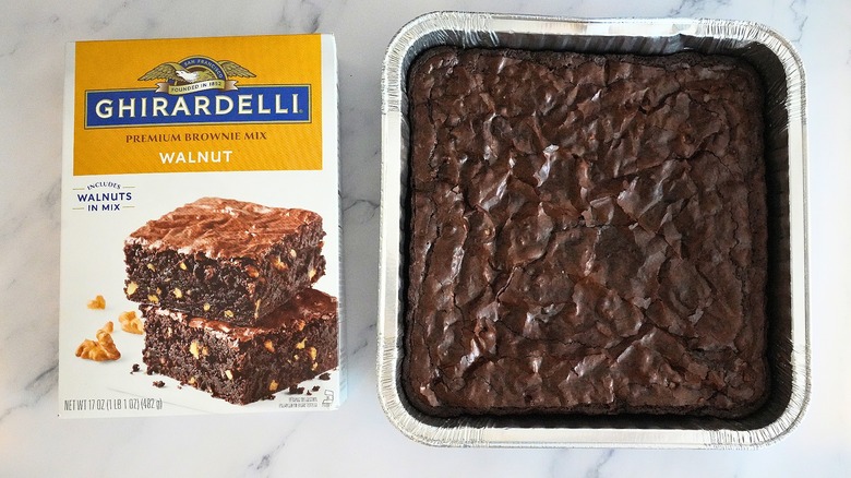 Ghirardelli Walnut Brownies in pan next to box on marble surface
