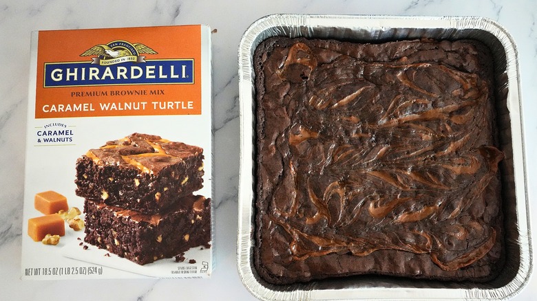 Ghirardelli Caramel Walnut Turtle Brownies in pan next to box on marble surface