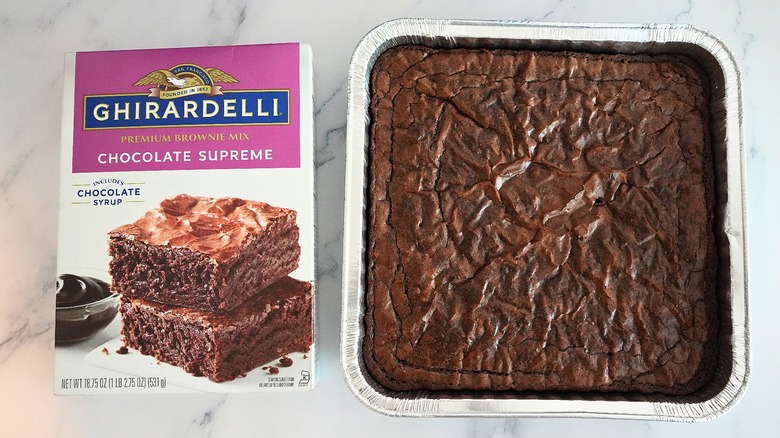 Ghirardelli Chocolate Supreme Brownies in pan next to box on marble surface