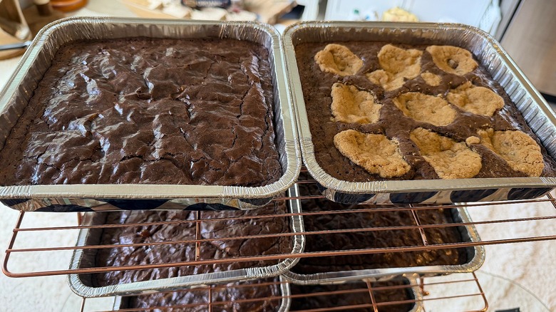 Several trays of brownies on cooling rack
