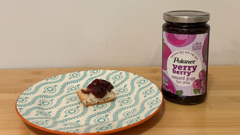 Polaner Fruit Spread with a piece of bread and the jelly on top next to it