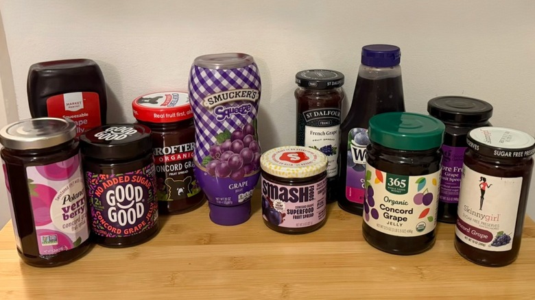 multiple jars of grape jelly on a table