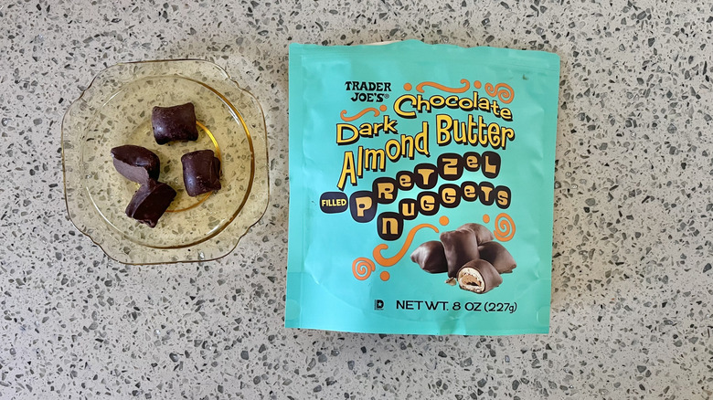 Four pieces of Dark Chocolate Almond Butter Pretzels on a plate