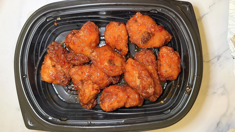 Walmart sweet heat boneless wings in container on marble surface