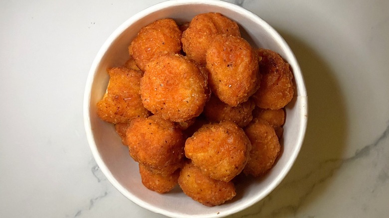 Walmart spicy popcorn chicken in container on marble surface