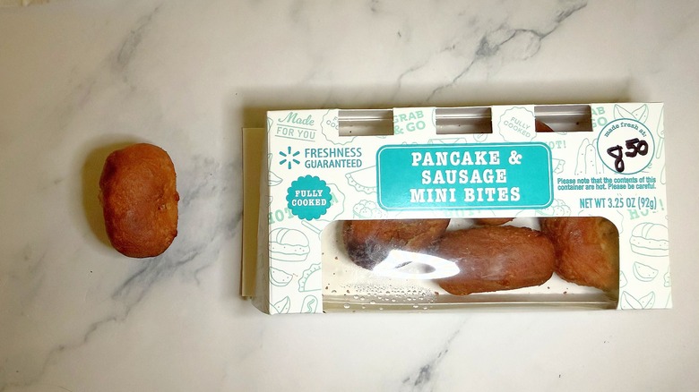 Pancake & Sausage Mini Bite next to container of bites on marble surface