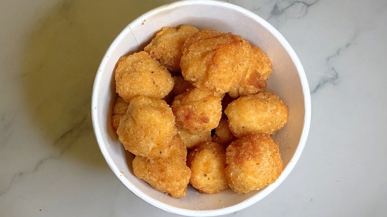 Walmart popcorn chicken in container on marble surface