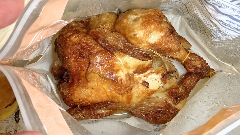 Walmart lemon pepper rotisserie chicken in bag on marble surface