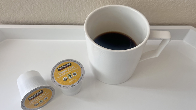 Two Summit Roast coffee pods with a mug
