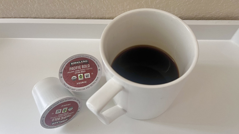 Pacific Bold coffee pod with a white mug