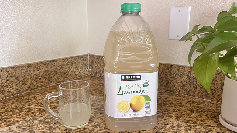 Glass of lemonade and organic lemonade jub