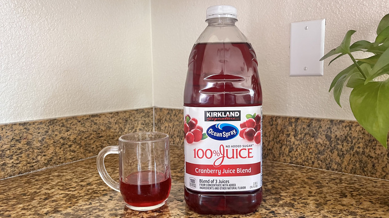 Cranberry juice blend jug with glass next to it
