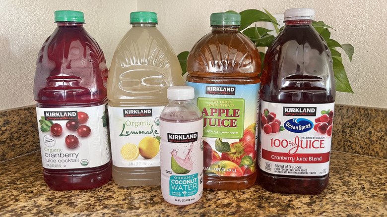 Different Kirkland juices lined up on the counter