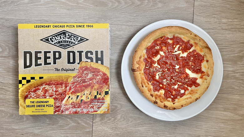 Top view of Gino's East Cheese Pizza on wooden background