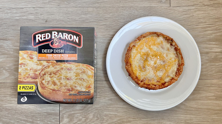 Top view of Red Baron Four Cheese Deep Dish Pizza on wooden background