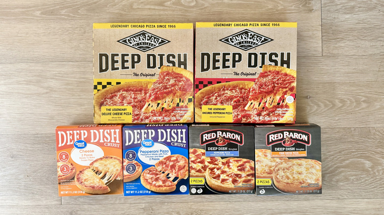 Top view of six deep dish pizzas on wooden background