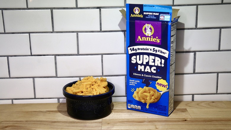 Annie's box and bowl of mac on a wooden counter
