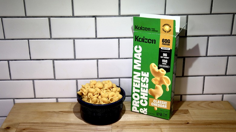 Kaizen box and bowl of cooked mac and cheese on a kitchen counter