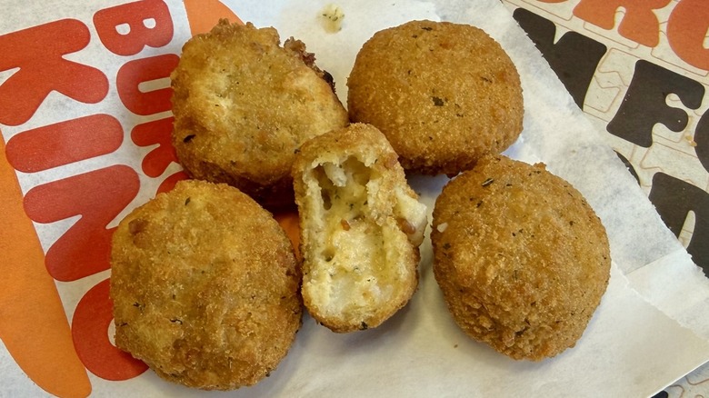 Burger King cheddar tots on a paper wrapper
