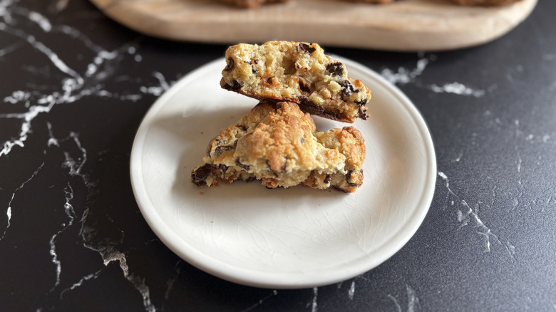 Levain caramel coconut chocolate chip cookie split in half on plate