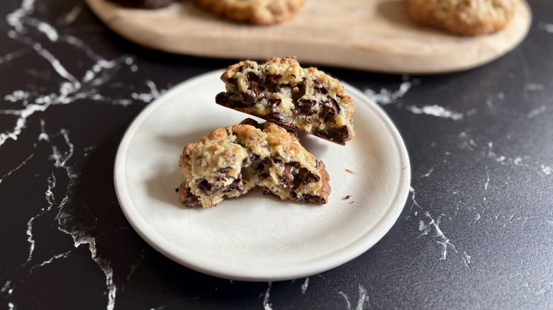 Levain chocolate chip cookie split in half on plate
