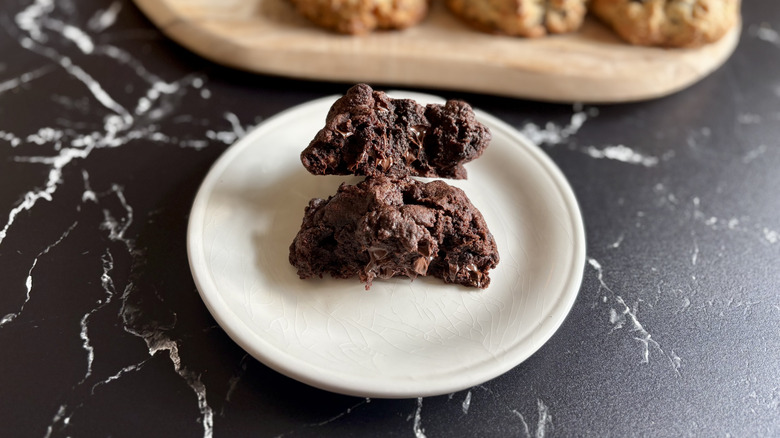 Levain dark chocolate chip cookie split in half on plate