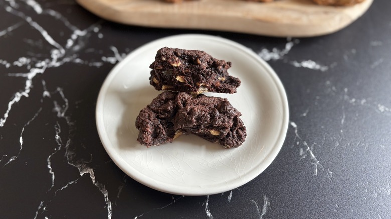 Levain dark chocolate peanut butter chip cookie split in half on plate