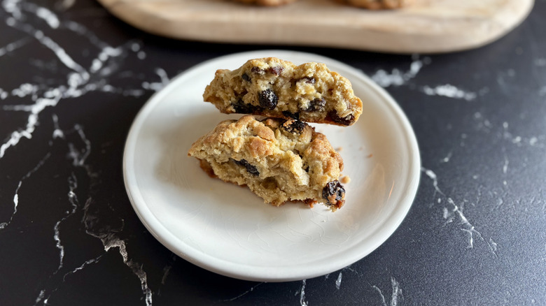 Levain oatmeal raisin cookie split in half on plate