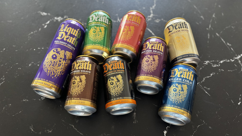 Various Liquid Death soda cans on countertop