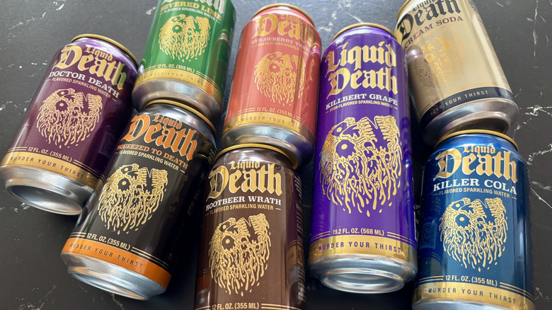 Various Liquid Death soda cans on countertop