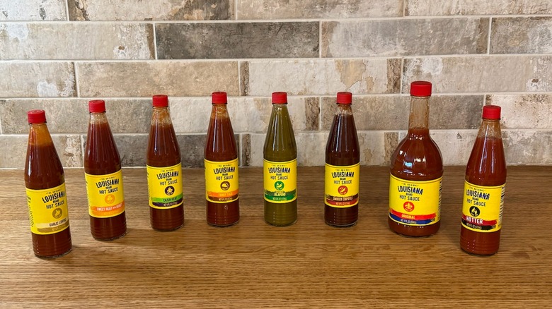 different flavors of Louisiana hot sauce lined up on counter