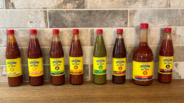 different flavors of Louisiana hot sauce lined up on counter